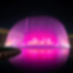 The Dubai Fountain illuminated at night showcasing its vibrant colors
